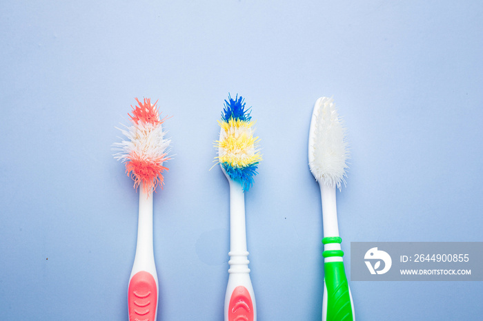 Used old toothbrush on blue background. dental care concept