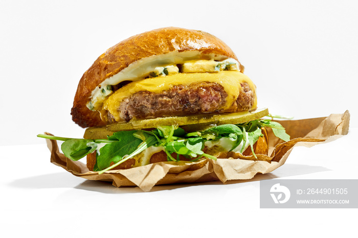 Juicy burger with cheese and arugula on a white background. Hard Light