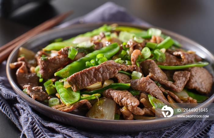 chinese beef and snowpeas stirfry on plate