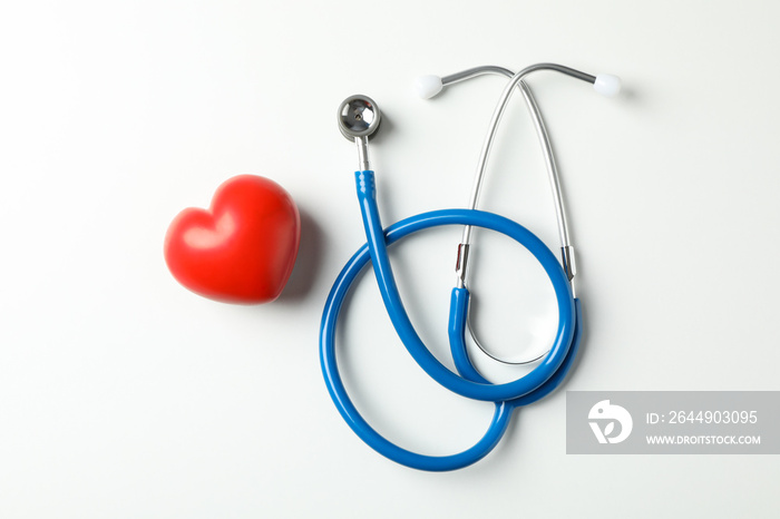 Stethoscope and heart on white background, space for text