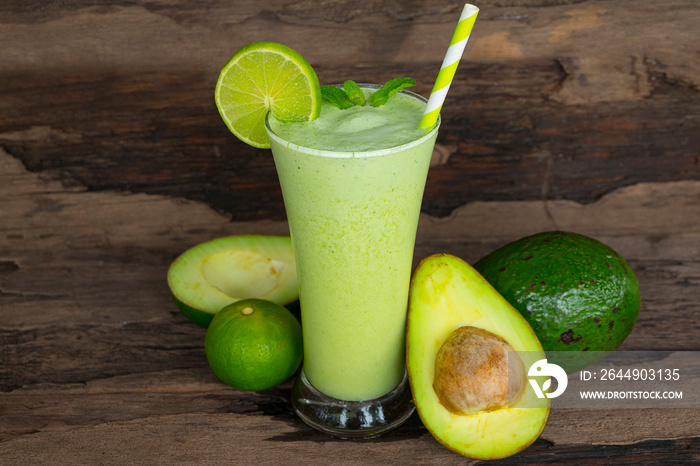 Avocado mix banana smoothies green colorful fruit juice milkshake blend beverage healthy high protein the taste yummy In glass,drink episode morning on a wooden background.