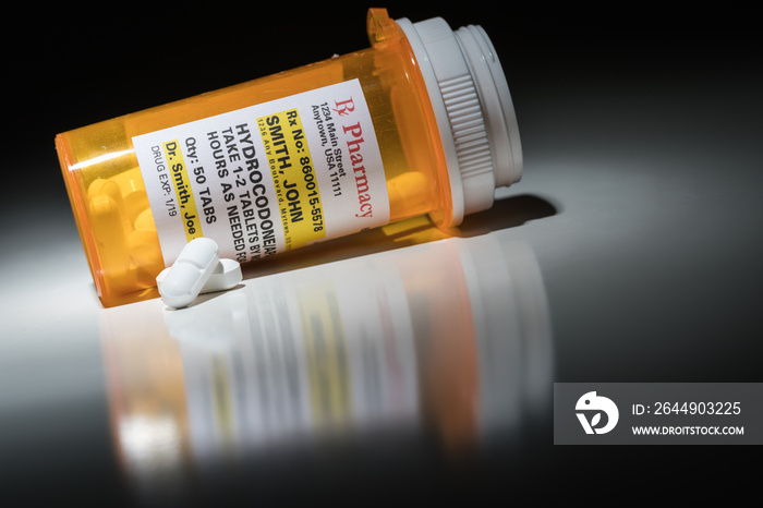 Hydrocodone Pills and Prescription Bottles with Non Proprietary Label. No model release required - contains ficticious information.