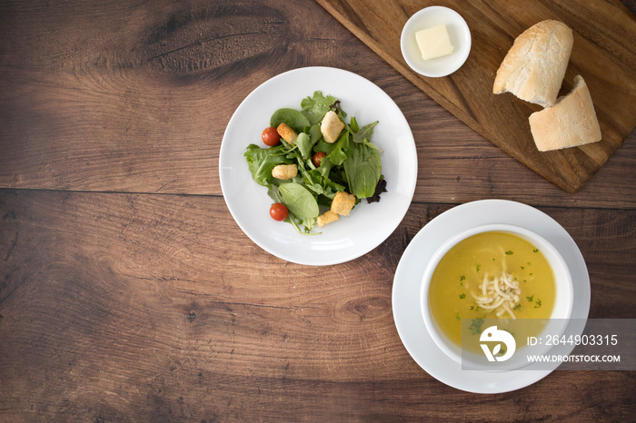 Chicken Noodle Soup and Salad on a Wooden Table