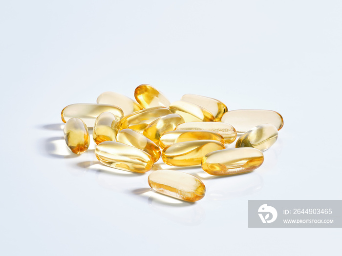 Closeup of many omega 3 oil capsules.