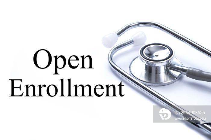 Page with Open Enrollment on the table with stethoscope, medical