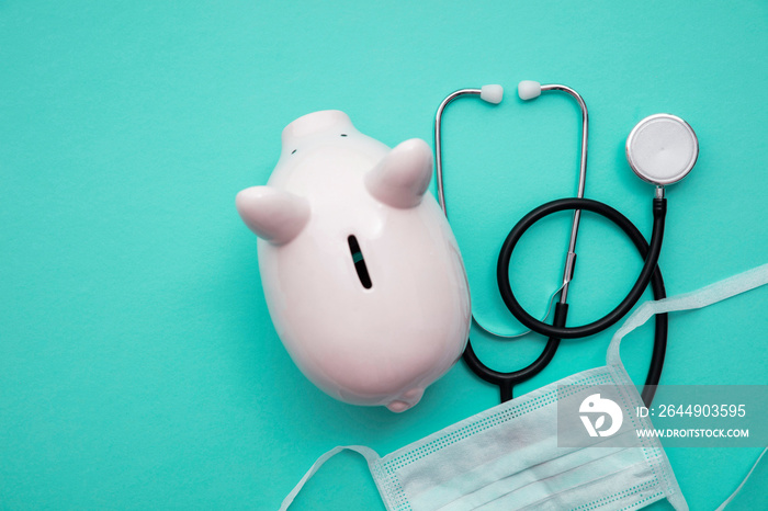 Cost of healthcare. Piggy bank money box with a medical doctors stethoscope