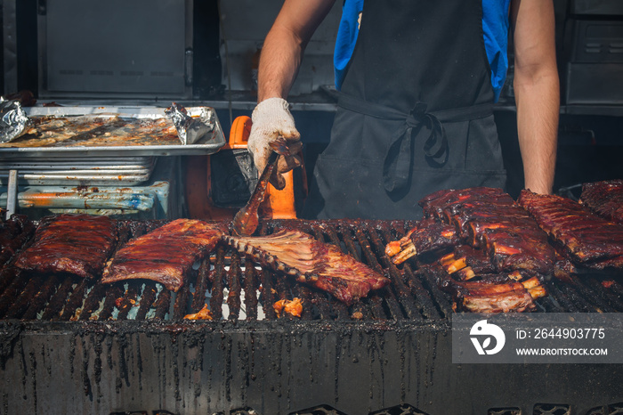 city of kamloops downtown, BC, Canada. Ribfest, Hot Nite in the City. Cooking Ribs, bbq chicken on the grill, massive, professional cooks, delicious sauce.