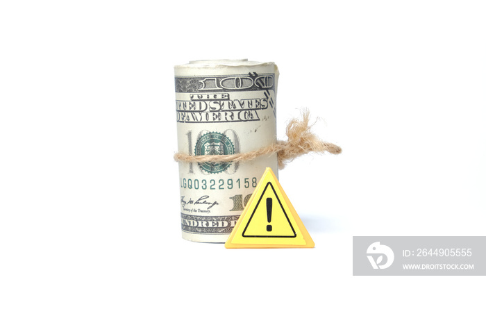 A picture of fake money with warning sign on white background. Financial crime concept.