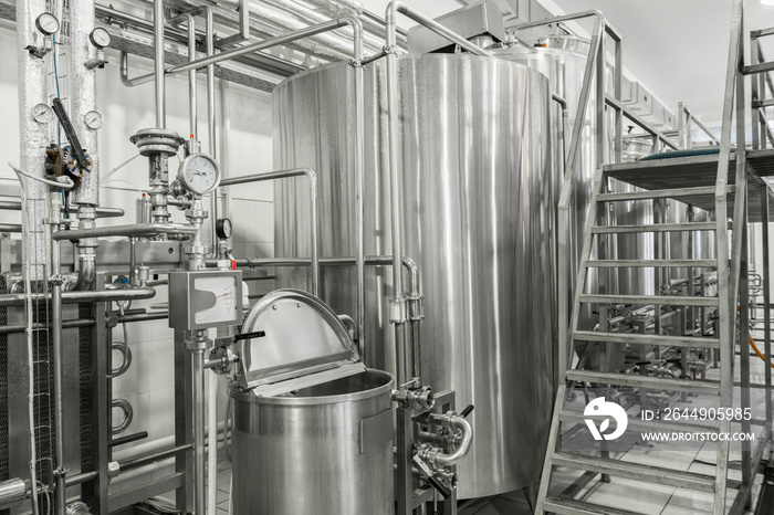 storage and pasteurization tank at the milk factory. equipment at the dairy plant