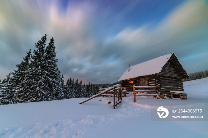 light in cozy hut in winter