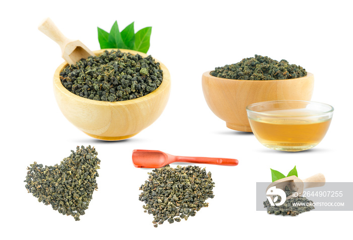 Dry green oolong tea in wooden bowl an isolated on white background with clipping path