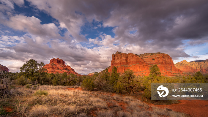 Clouds and blue sky over Bell Rock and Courthouse Butte between the Village of Oak Creek and the town of Sedona in northern Arizona in Coconino National Forest, United States of America