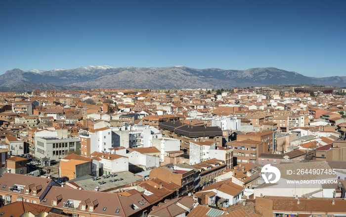 Views of the city of Colmenar Viejo, Madrid, Spain, from the belltower of the Basilica of La Asuncion de Nuestra Señora. In the background, it can be seen Guadarrama Mountains Range