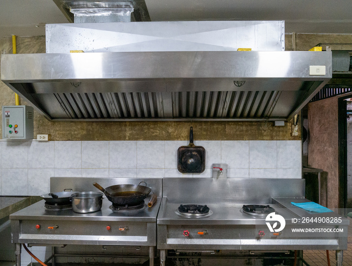 Kitchen with cooking equipment And the hood