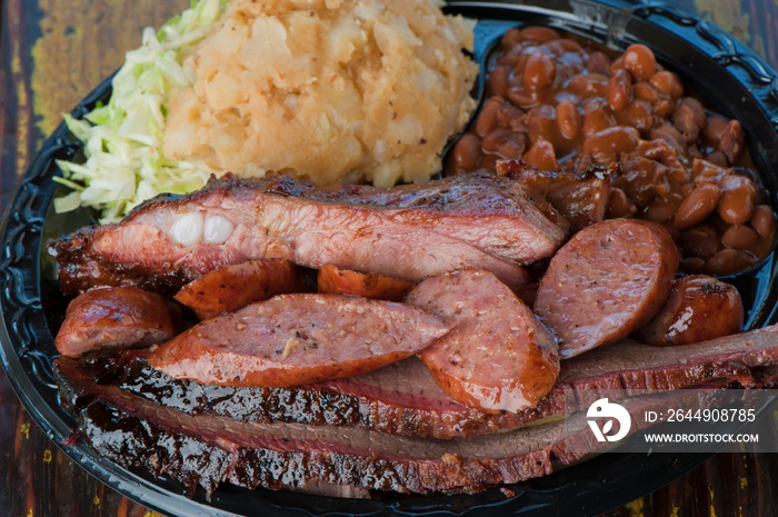 Brisket, pork sausage, pork ribs, beef ribs. Barbecue platter served with classic bbq sides Mac n cheese, cornbread, Brussels sprouts, coleslaw & beer. Classic traditional Texas meats & side dishes.