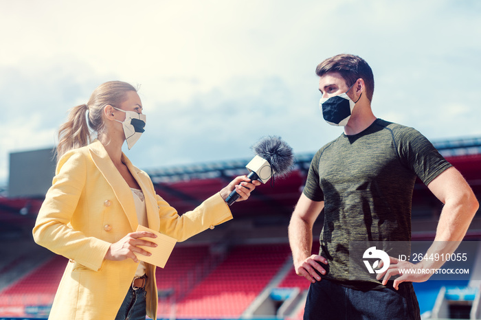 Reporter doing interview with football player during covid-19