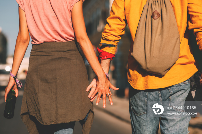 Young couple holding hands while going to a music festival