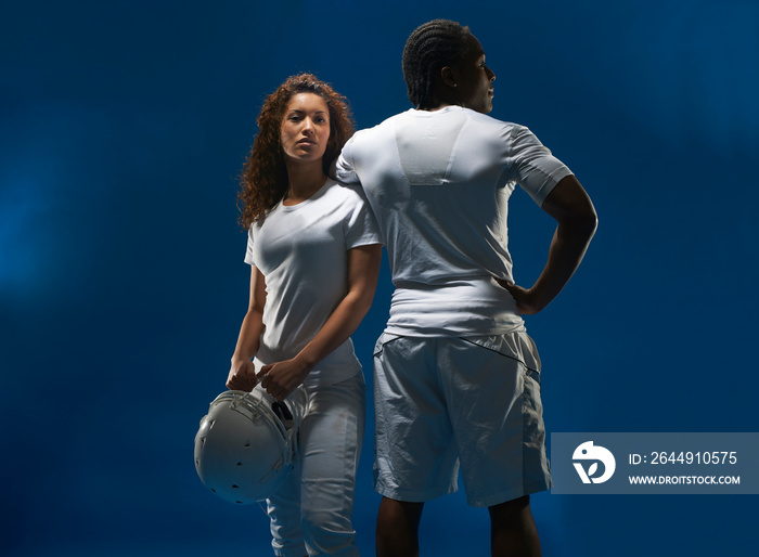 Portrait of female american footballer with trainer