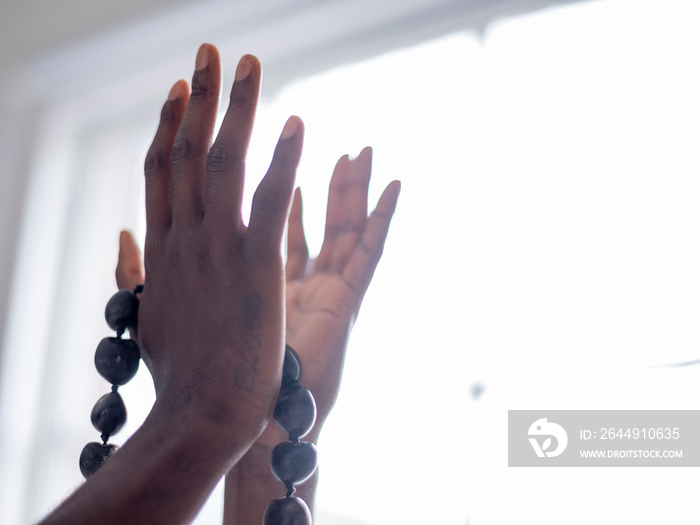 Close-up of hand holding prayer beads