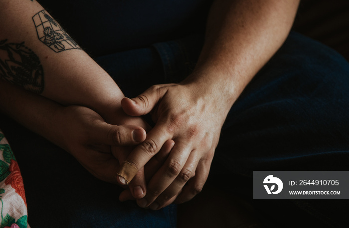 closeup of couple holding hands