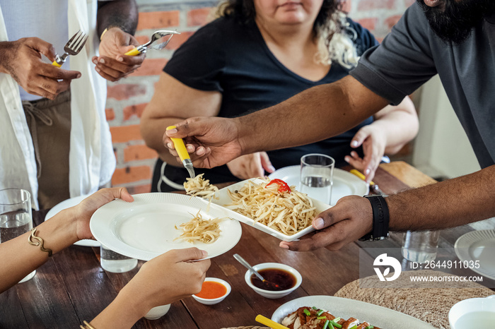 Group of friends sharing a meal together at home