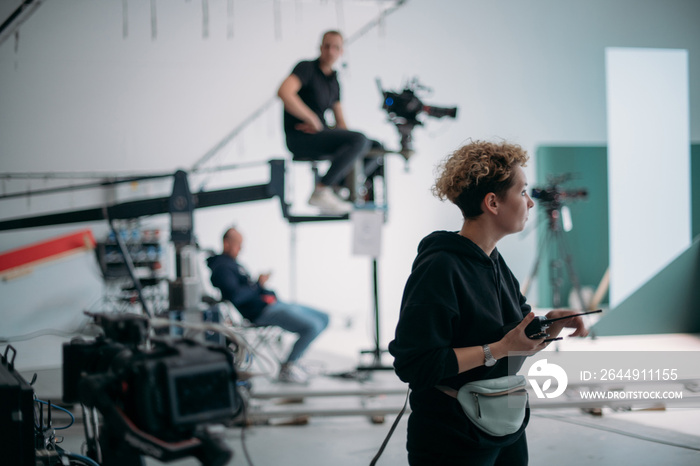 Director at work on the set. The director works with a group or with a playback while filming a movie, advertising