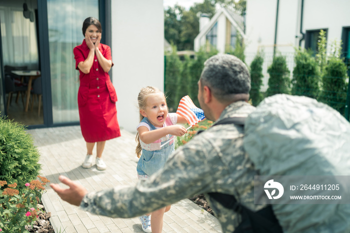 Cute little daughter feeling extremely emotional seeing daddy