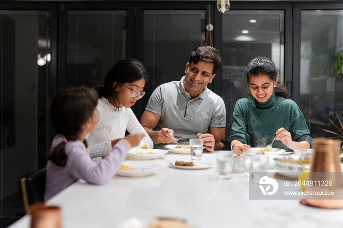 Family dining at home in evening