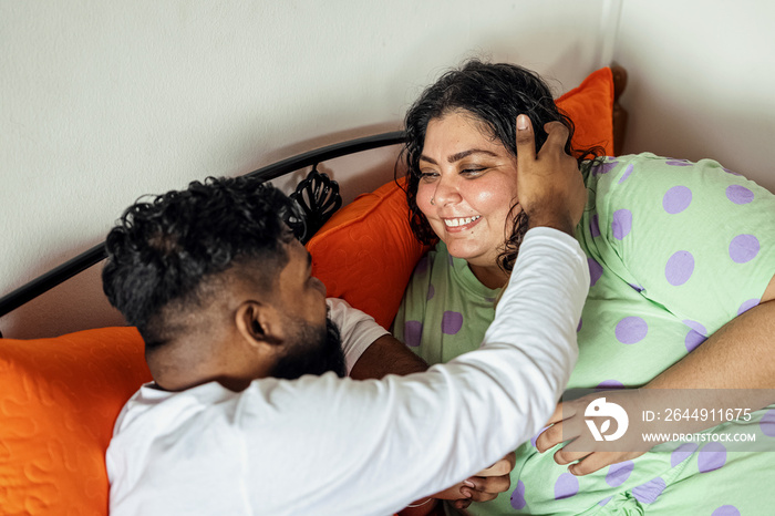 Couple chatting after waking up in the morning