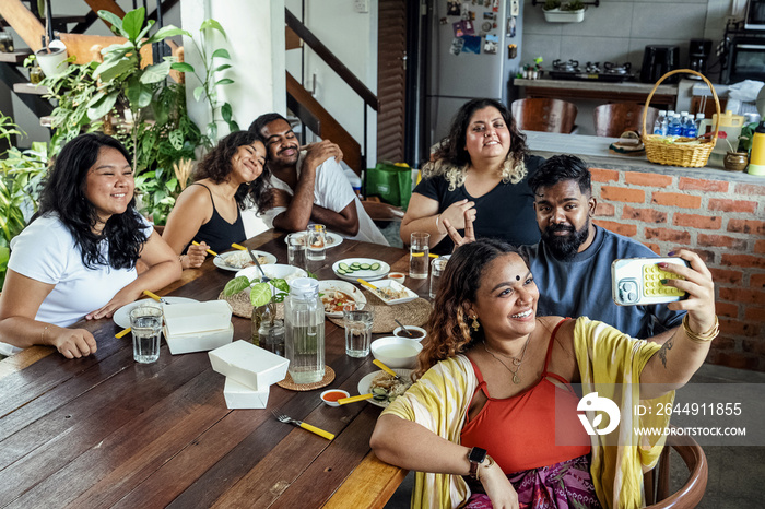 Group of friends sharing a meal together at home