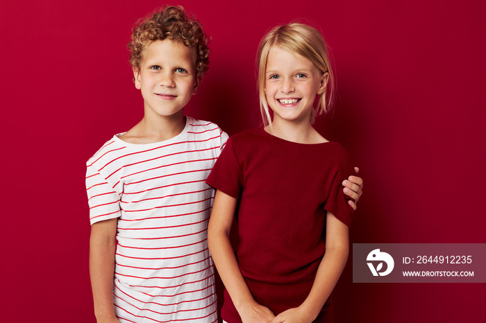 picture of positive boy and girl good mood standing next to posing isolated background