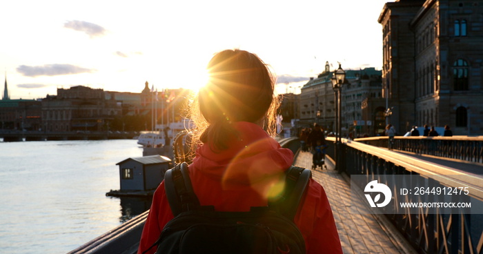 Stockholm, Sweden. Young Caucasian Woman Lady Tourist Traveler Walking On Famous Skeppsholmsbron - Skeppsholm Bridge. Popular Place, Landmark And Destination In Stockholm, Sweden