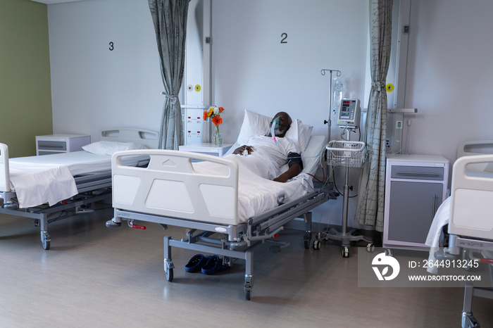 African american male patient lying on hospital bed wearing oxygen mask ventilator