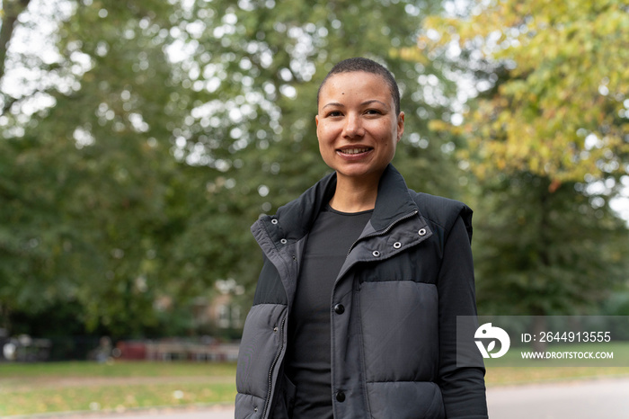 Portrait of smiling woman in sports clothing in park