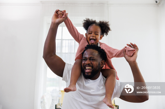 enjoy happy love black family african american father carrying daughter little african girl child smiling and having fun moments good time.  American father day concept.