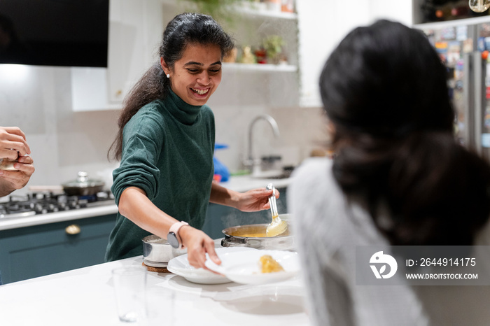 Woman serving food to daughter