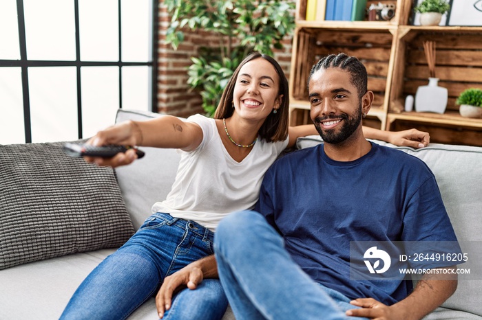 Man and woman couple smiling confident watching tv at home