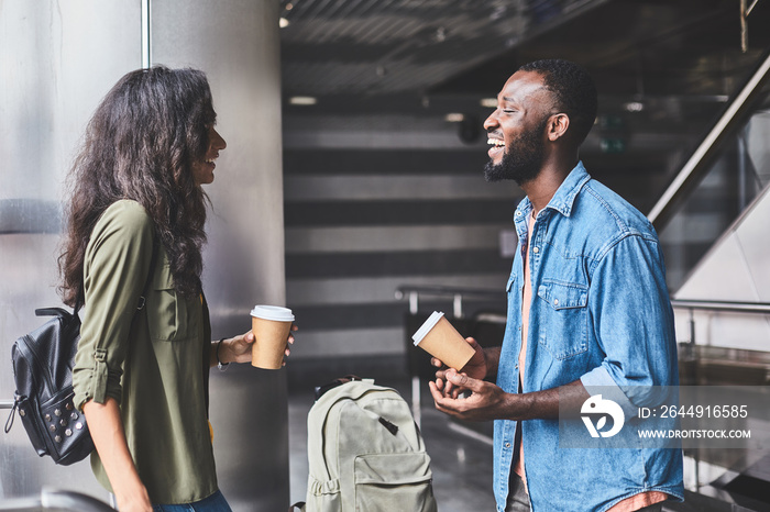 Happy young couple talking with each other in shopping center