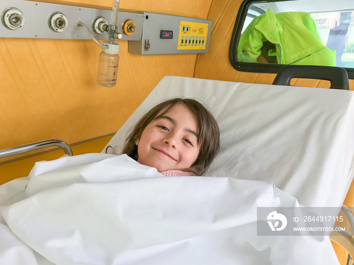 Baby girl happy in ambulance bed