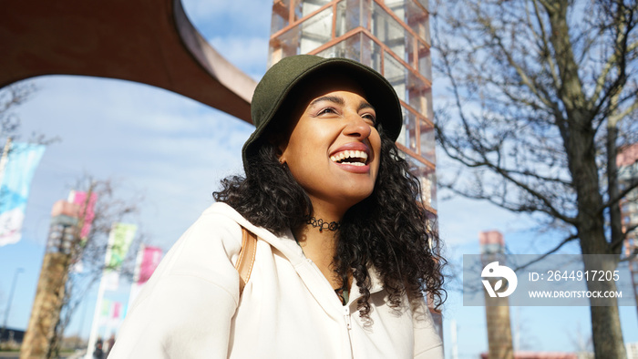 Smiling woman in hat outdoors