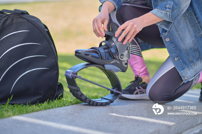 Fit legs in kangoo jumping shoes. womanpreparing for Kangoo Jumping training