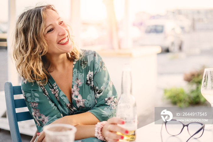 portrait of a woman drinking beer outdoor