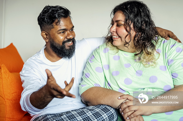 Couple chatting after waking up in the morning