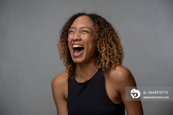 Portrait of laughing woman with curly hair