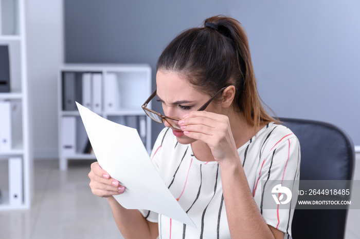 Businesswoman with bad sight working in office