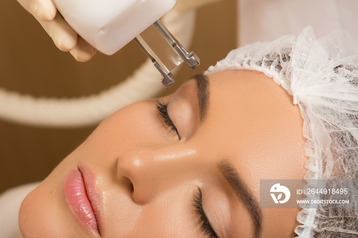 Beautiful woman in  beauty salon during rejuvenation procedure