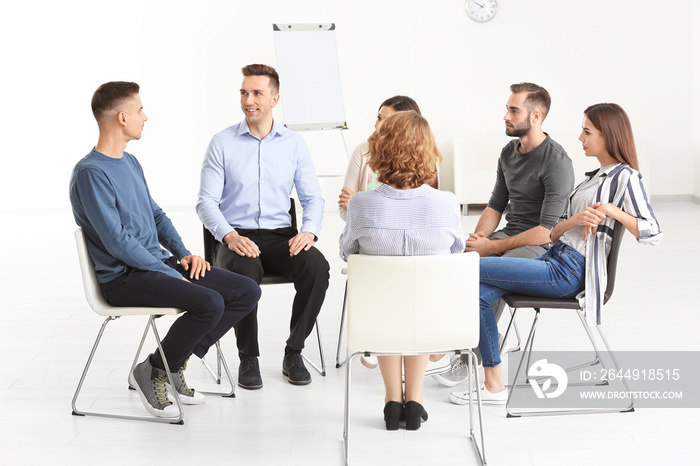 People at group psychotherapy session indoors