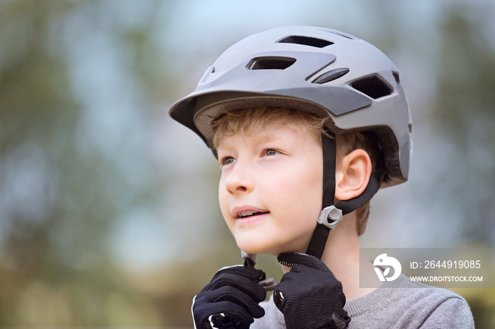 kid putting bike helmet on