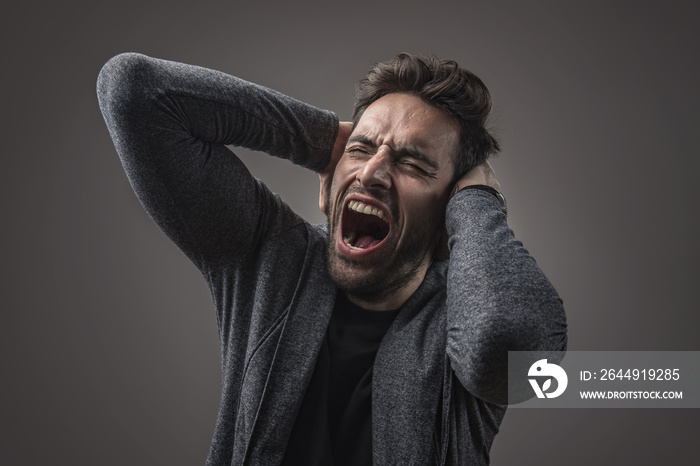 Enraged troubled man screaming in anger, crazy and mental