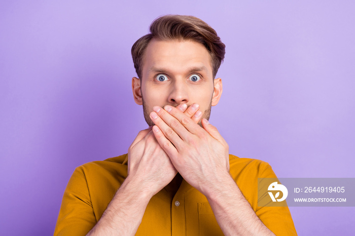 Photo of young man unhappy close cover mouth hands oops fail mistake worried isolated over violet color background